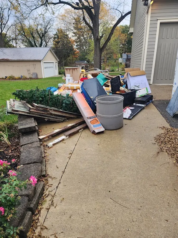 Dumpster being loaded with debris for Estate Cleanout Dumpster Rental in Santa Maria